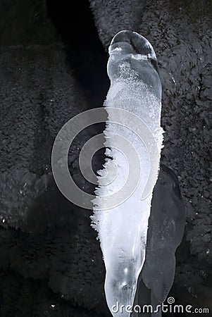 Ice stalagmite in the cave Stock Photo